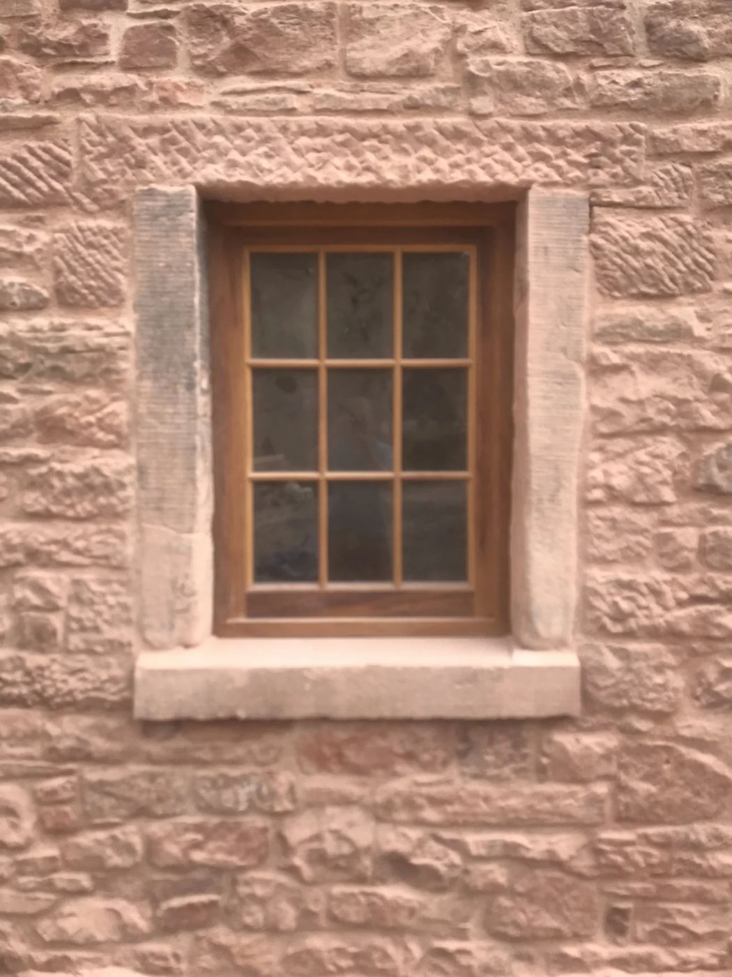 Bespoke window fitted on new build stone castellation